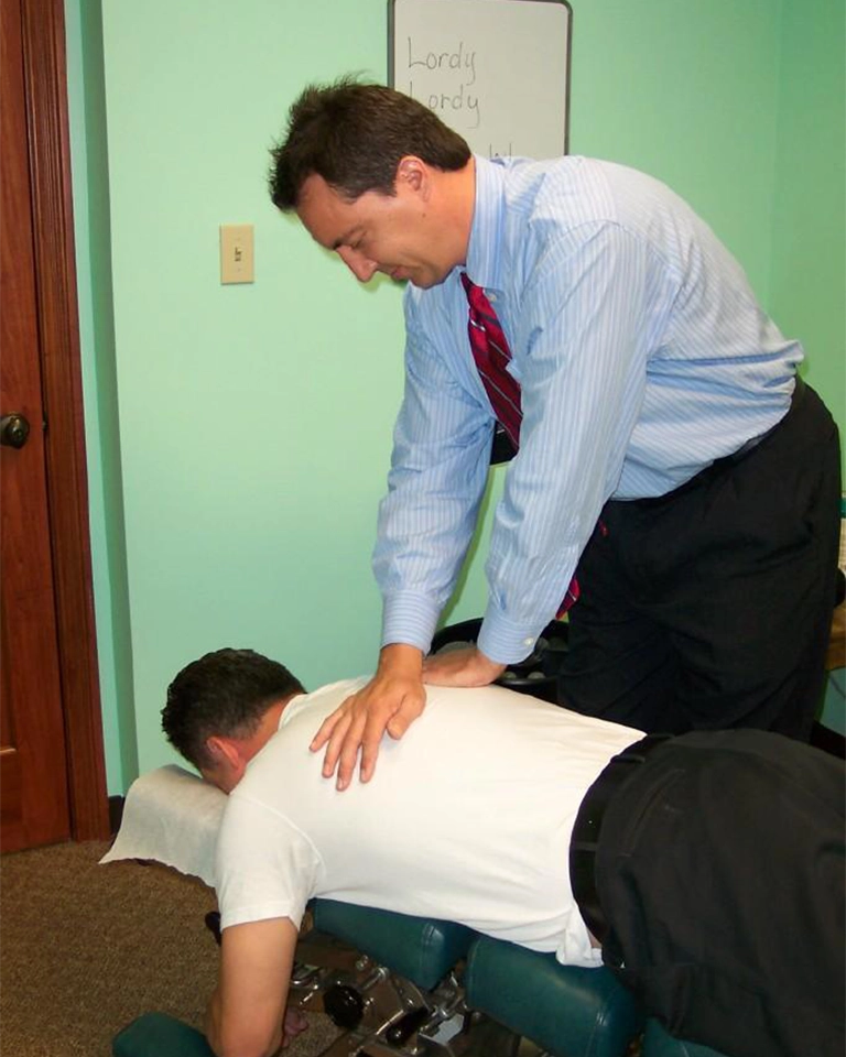 Chiropractor-Indianapolis-IN-Jeffry-Yoder-Adjusting-Patient-HP.webp